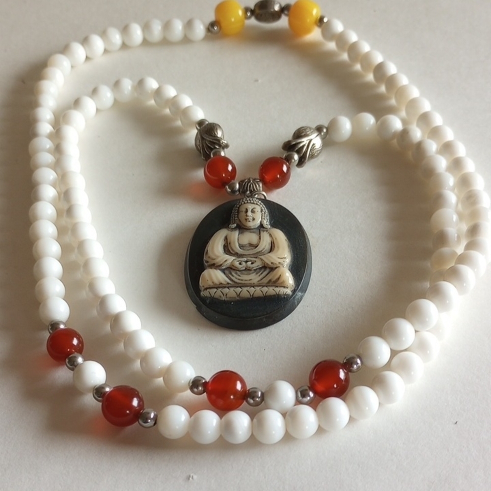Elegant White and Red Beaded Necklace with Buddha Pendant 30" long, signed.